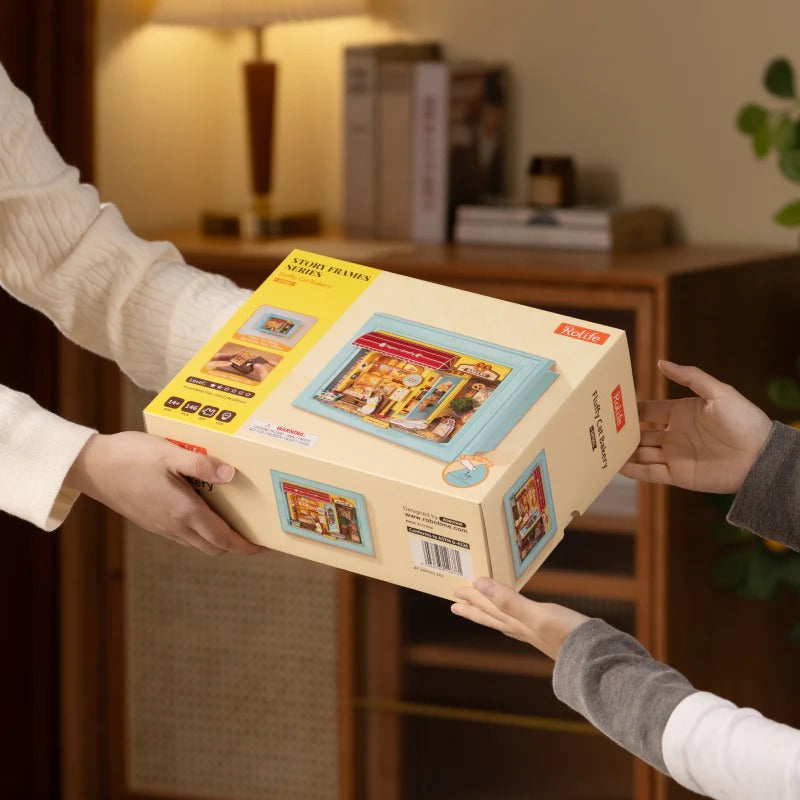Rolife Fluffy Cat Bakery DP001 gift box being handed over as a DIY model kit present