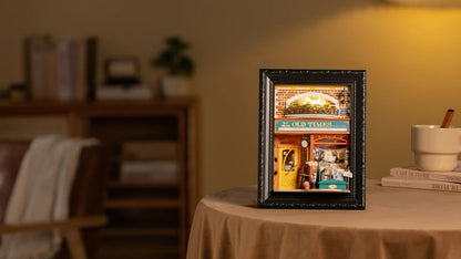 Rolife Old Times Bookstore DP004 illuminated story frame displayed on a warm tabletop scene