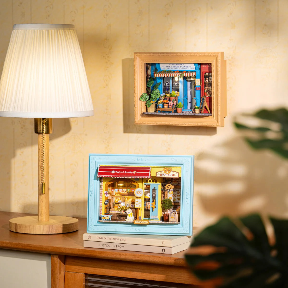 Rolife Fluffy Cat Bakery DP001 story frame displayed as warm home decor beside a lamp