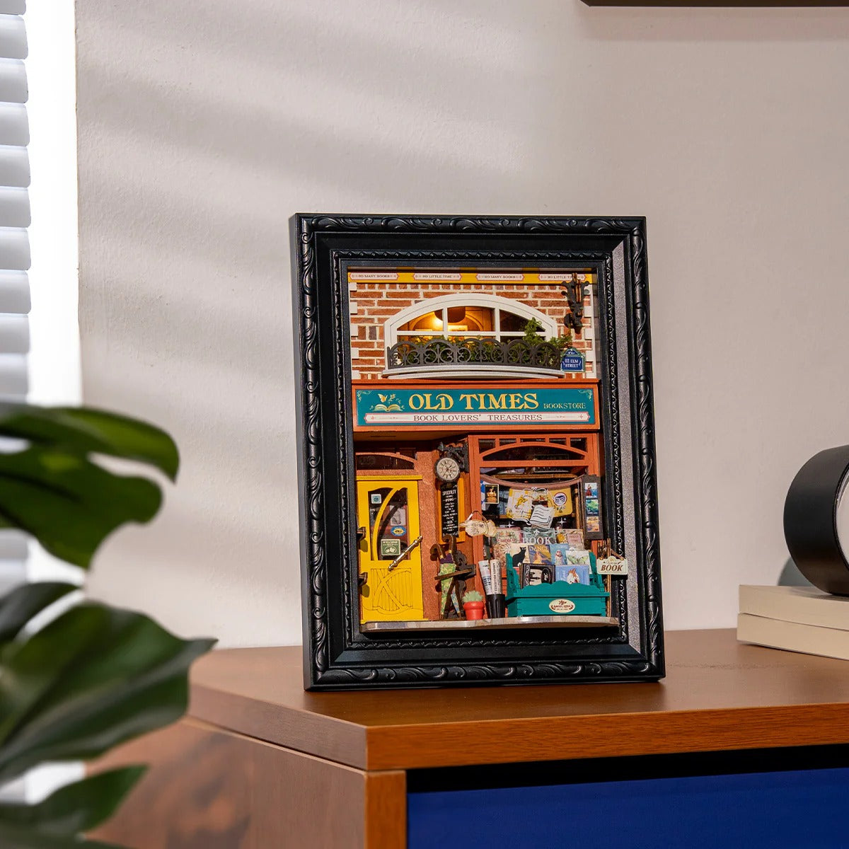 Rolife Old Times Bookstore DP004 assembled model displayed as cosy home decor on a wooden cabinet