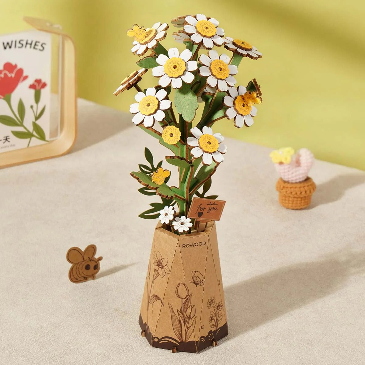 Rowood Chamomile TW061 wooden flower puzzle displayed on a table with soft yellow background