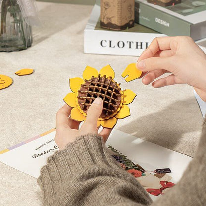 Hands assembling the Rowood Sunflower TW011 wooden flower petals and centre pieces