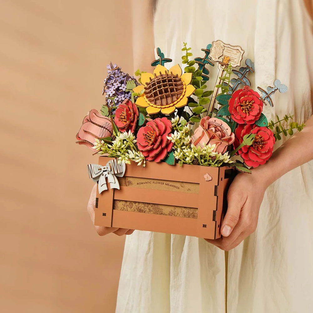 Person holding the Rowood Wooden Bloom Box TW02H finished wooden flower arrangement outdoors