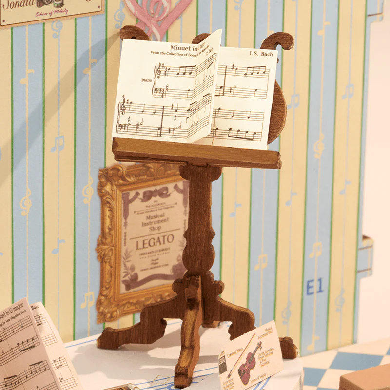 Close-up of music stand and sheet music detail inside Rolife Melody Instrument Shop DS047