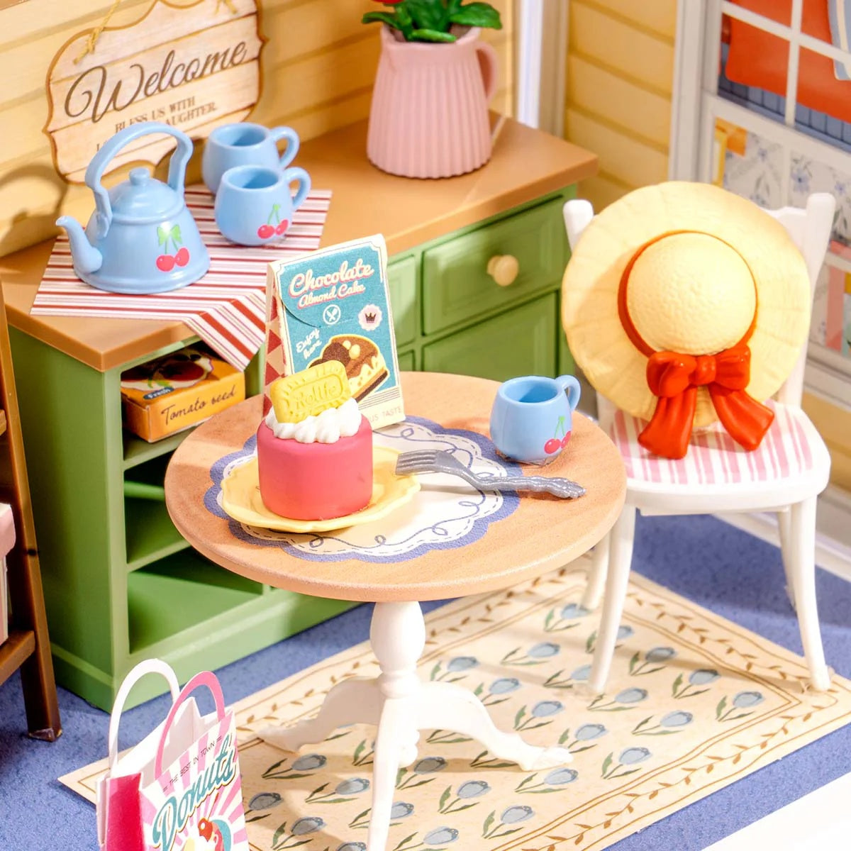 Close-up of the Sunshine Sip Porch DWS07B tea set, cake table, chair and miniature decor details.