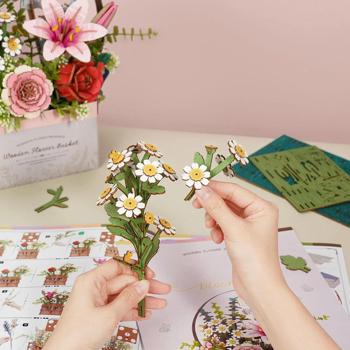 Hands assembling the daisy stem for Rowood Wooden Flower Basket TW03H DIY wooden flower puzzle kit
