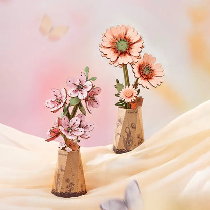 Rowood Light Orange Gerbera Daisy TW111 displayed in a soft pastel gift scene with another wooden flower kit