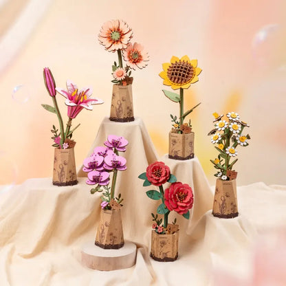 Rowood Light Orange Gerbera Daisy TW111 shown with other Rowood wooden flower kits in a mixed flower collection display