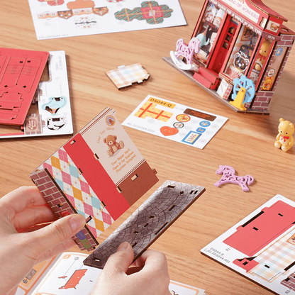 Rolife Whimsy Toy Shop DS044 assembly process with wooden parts, stickers, and instruction pieces.
