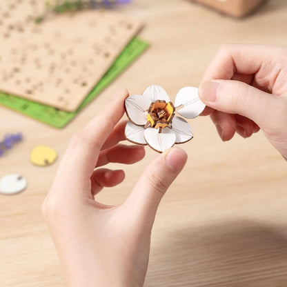 Rowood Narcissus TF002 wooden daffodil flower assembly close-up with hands placing flower petals
