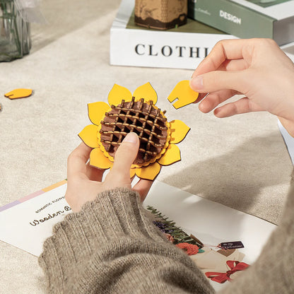 Hands assembling the sunflower petals for the Rowood Wooden Flower Bouquet TW01H DIY wooden flower bouquet kit.