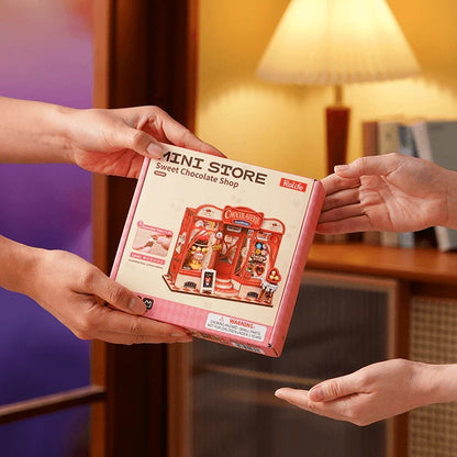 Rolife Sweet Chocolate Shop DS046 product box packaging being handed as a creative DIY gift