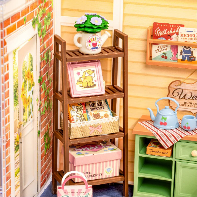Close-up of the Sunshine Sip Porch DWS07B wooden garden shelf with books, basket and miniature decor.