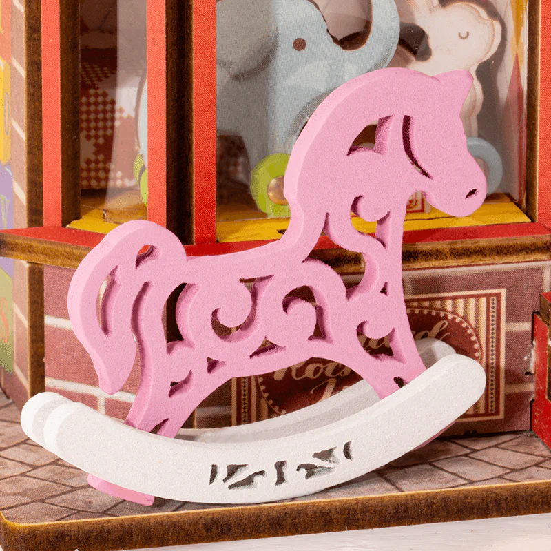 Detailed close-up of the pink rocking horse accessory on Rolife Whimsy Toy Shop DS044.