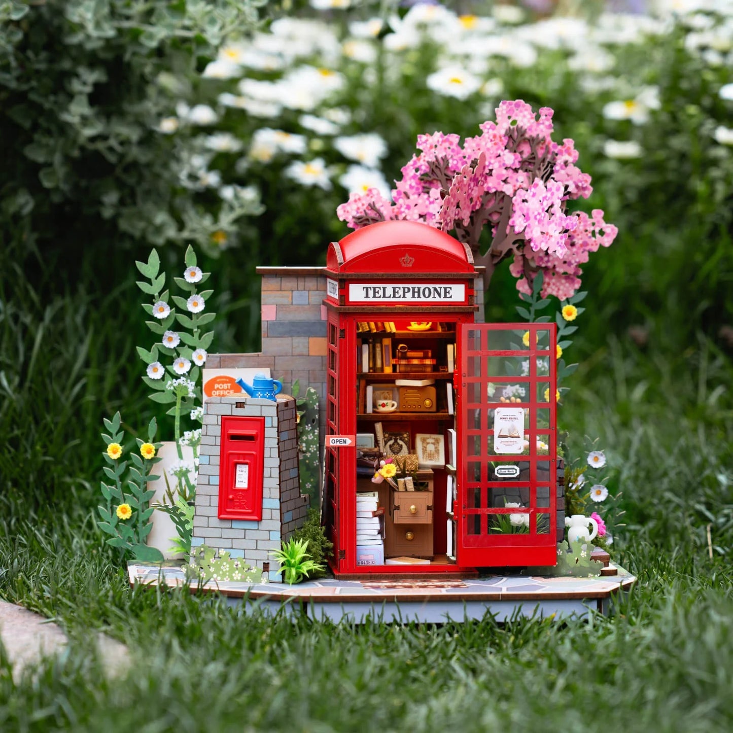 Rolife Blossom Book Booth TGS05 DIY miniature scene displayed in a garden setting