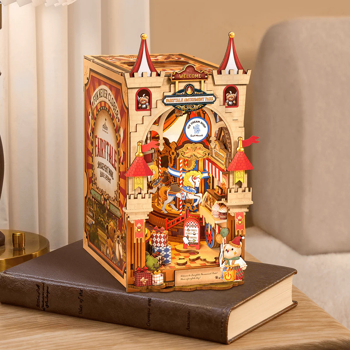 Rolife Tipsy Restaurant TGB17 DIY Miniature House Kit displayed on book with warm LED lights